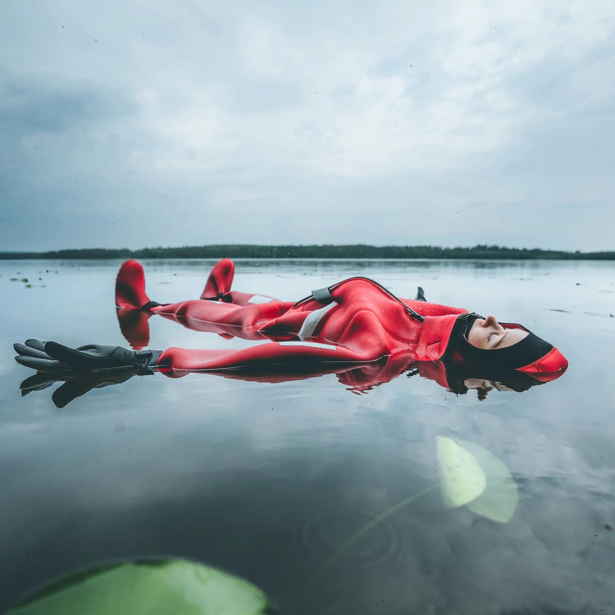 Woman enjoying summer activity in lLpaland and floating on lake. | Arctic TreeHouse Hotel