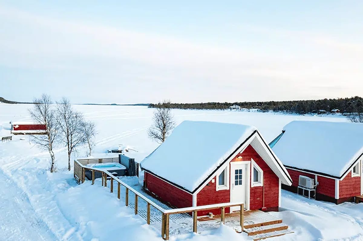 Aurora Sauna &amp; Hot Spring in snowy landscape. 